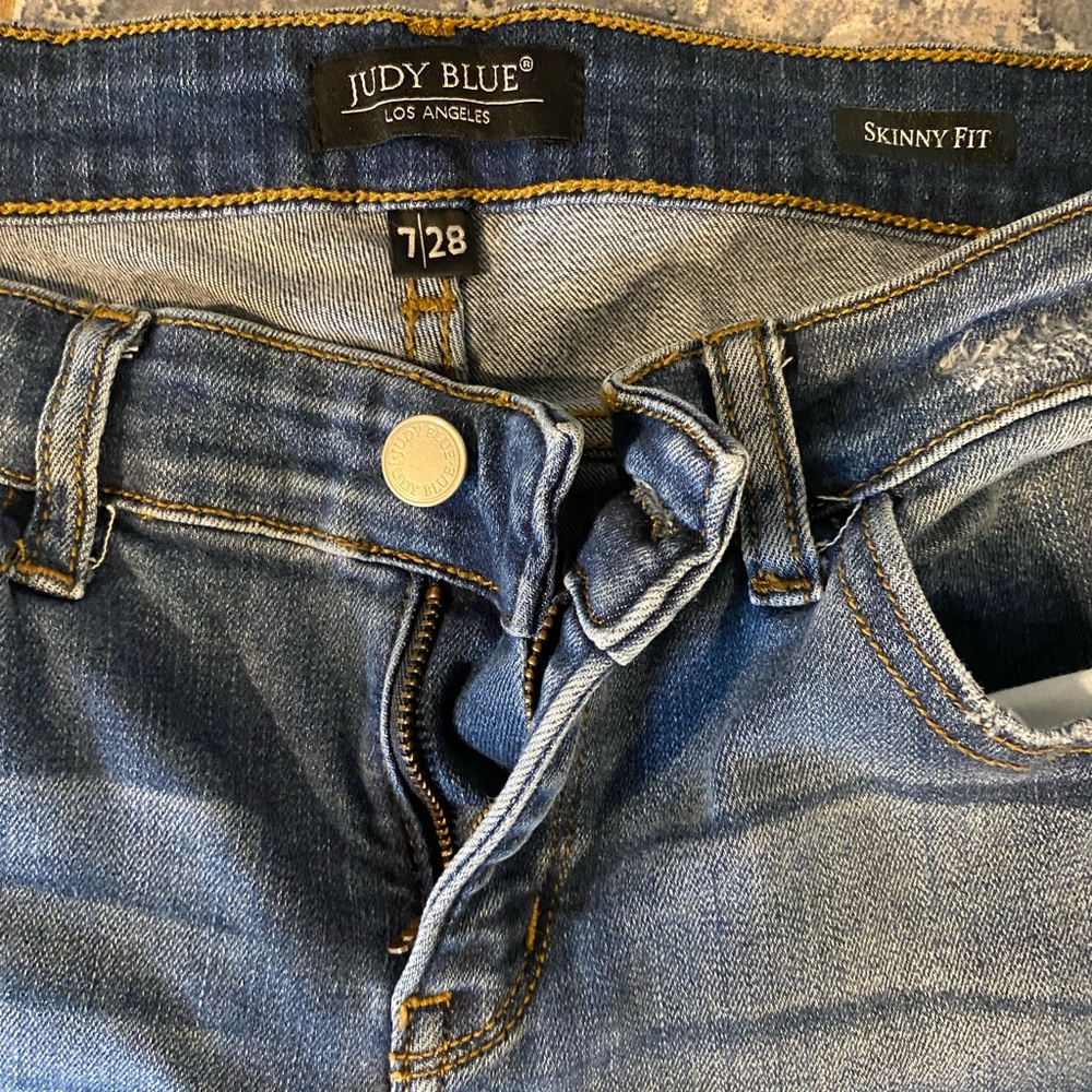 Skinny blue jeans distressed with leopard patches, like new they were worn twice